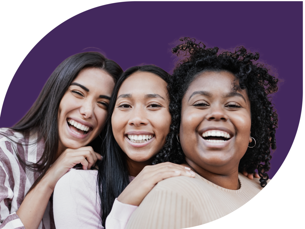 3 Latina women smiling with a purple background